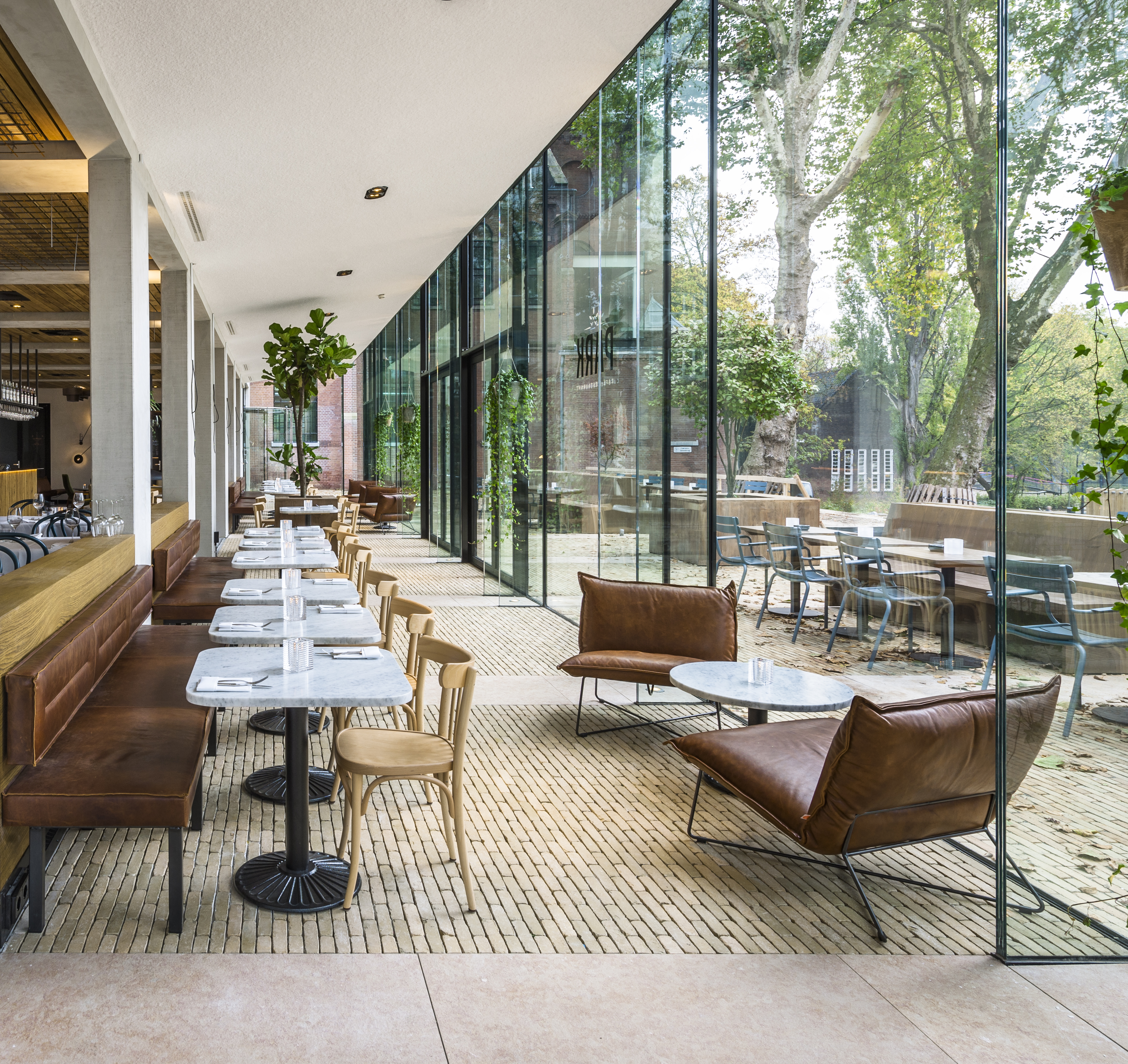 Bronze Yellow Ancienne Belgique forms link between transparent pavilions and terrace